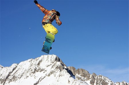 simsearch:400-03985663,k - Young snowboarder jumping high over the mountains Stock Photo - Budget Royalty-Free & Subscription, Code: 400-05029874