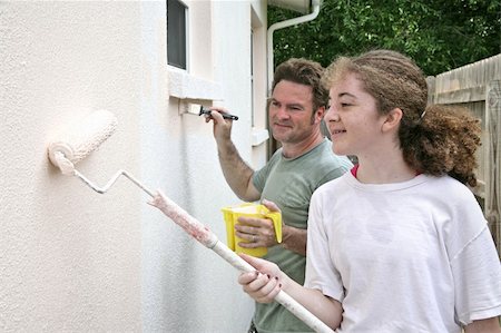 A horizontal view of a father and daughter painting their house together. Stock Photo - Budget Royalty-Free & Subscription, Code: 400-05021227