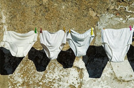 peg - Knickers drying hanged in a cloth line Stock Photo - Budget Royalty-Free & Subscription, Code: 400-05022179