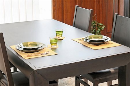 Modern black dinning table with green plates Stock Photo - Budget Royalty-Free & Subscription, Code: 400-05035081