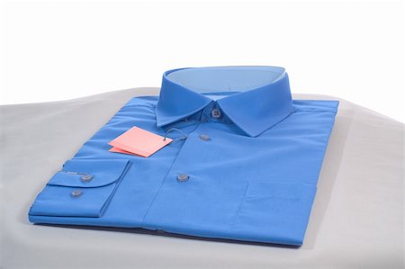 new blue man shirt on grey podium, close-up, isolated on white Stock Photo - Budget Royalty-Free & Subscription, Code: 400-05035356