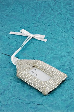 simsearch:400-04499144,k - Elegant beaded gift tag on a textured background Stock Photo - Budget Royalty-Free & Subscription, Code: 400-05033377