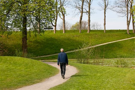 simsearch:400-05044143,k - Lonely man walking around the embankments of Nyborg - Denmark. Stock Photo - Budget Royalty-Free & Subscription, Code: 400-05044102