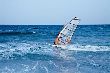 simsearch:400-03992760,k - windsurfer sailing away form the beach on blue waters Stock Photo - Budget Royalty-Free & Subscription, Code: 400-05047045