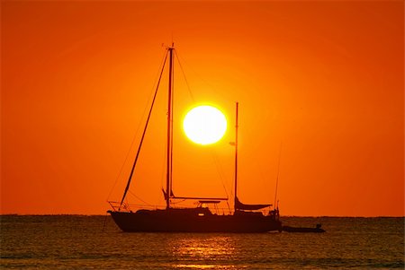 simsearch:400-04377093,k - Sailing boat silhouette and golden sunrise over the ocean Stock Photo - Budget Royalty-Free & Subscription, Code: 400-05048977