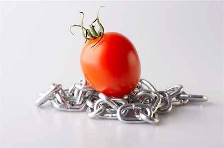 simsearch:400-07578126,k - Red tomato with a chain on a white background Stock Photo - Budget Royalty-Free & Subscription, Code: 400-05041892