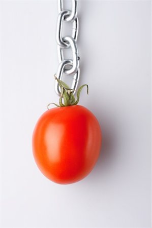simsearch:400-07578126,k - Red tomato hanging on a chain Stock Photo - Budget Royalty-Free & Subscription, Code: 400-05041893