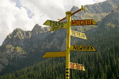 The signpost from meta indicating a managements seven large cities of the world, on a background of mountains. Stock Photo - Budget Royalty-Free & Subscription, Code: 400-05054305