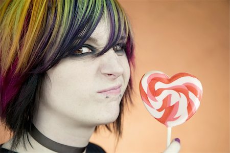simsearch:400-04016564,k - Alternative Girl with a Heart Lollipop Scrunches her Face Stock Photo - Budget Royalty-Free & Subscription, Code: 400-05053749