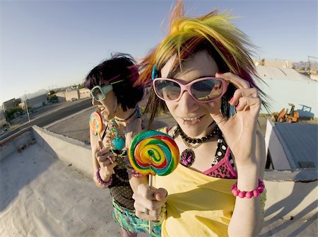 simsearch:400-04016564,k - Fisheye shot of girls in brightly colored clothing on a roof with sunglasses and lollipops Stock Photo - Budget Royalty-Free & Subscription, Code: 400-05053755