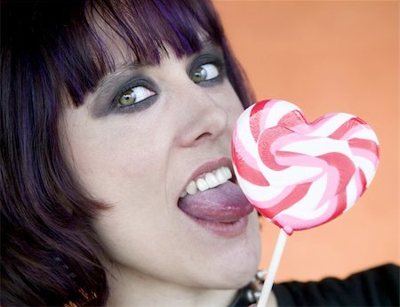 Close-up of an Alternative Girl with a Heart Lollipop Stock Photo - Budget Royalty-Free & Subscription, Code: 400-05053768