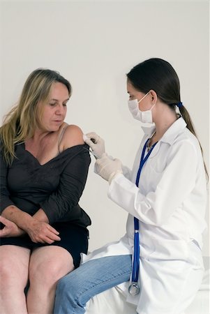 patient injection arm not children - Older female patient about to receive an injection from a younger female doctor Stock Photo - Budget Royalty-Free & Subscription, Code: 400-05060110