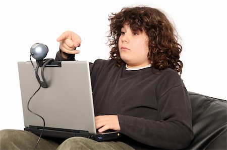 boy using laptop and webcam on white background Stock Photo - Budget Royalty-Free & Subscription, Code: 400-05060993