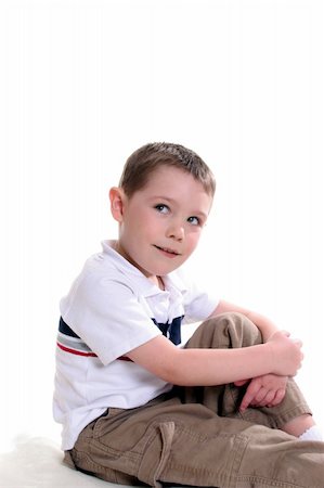 Boy sitting with one knee up and his arms around the knee; looking up and off to the side. Stock Photo - Budget Royalty-Free & Subscription, Code: 400-05074614