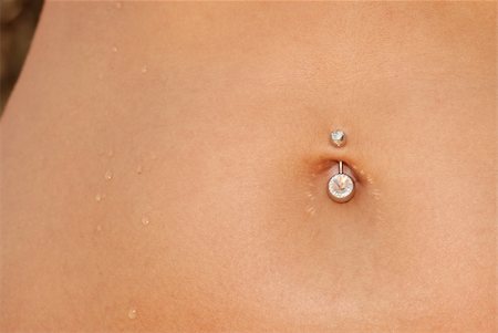 simsearch:400-04435419,k - Piercing in a navel. A female body with a jewel - piercing Stock Photo - Budget Royalty-Free & Subscription, Code: 400-05076596