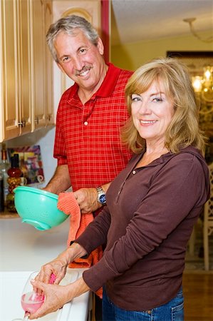 Beautiful mature couple sharing the household chores, doing dishes together. Stock Photo - Budget Royalty-Free & Subscription, Code: 400-05071732