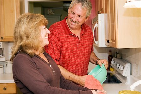 Beautiful mature couple doing dishes together and smiling. Stock Photo - Budget Royalty-Free & Subscription, Code: 400-05071733