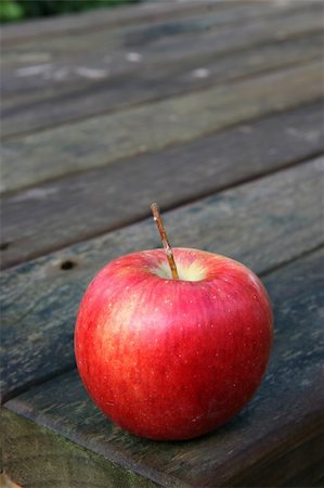 simsearch:400-05674030,k - Red apple on a weathered wooden garden or park table shot vertically Stock Photo - Budget Royalty-Free & Subscription, Code: 400-05072779
