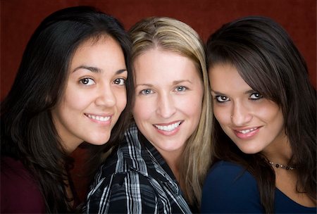 simsearch:400-04099373,k - Three smiling young women in a studio setting Stock Photo - Budget Royalty-Free & Subscription, Code: 400-05085699