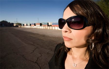 Pretty Hispanic woman with dark sunglasses in an urban setting Stock Photo - Budget Royalty-Free & Subscription, Code: 400-05086735