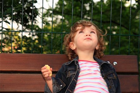 dreaming about eating - The child is looking up to the sky, sitting on the bench. Stock Photo - Budget Royalty-Free & Subscription, Code: 400-05080464