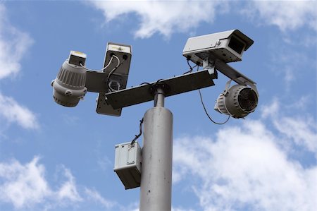 Security cameras watching over us on a sunny day Stock Photo - Budget Royalty-Free & Subscription, Code: 400-05081201