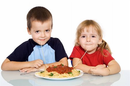 Happy kids eating pasta - isolated Foto de stock - Super Valor sin royalties y Suscripción, Código: 400-05083790