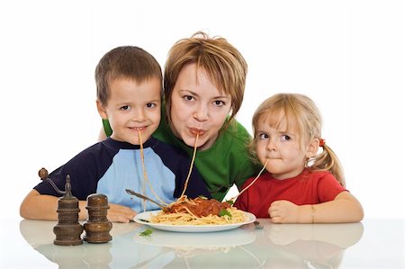 Happy smiling woman and kids eating pasta - isolated Stock Photo - Budget Royalty-Free & Subscription, Code: 400-05083791