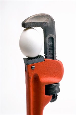 simsearch:400-03947919,k - pipe wrench with an egg in it's jaws Stock Photo - Budget Royalty-Free & Subscription, Code: 400-05098975