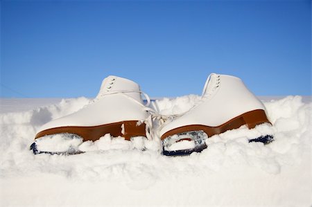 Closeup of figure skating ice skates lying in the snow outdoors Stock Photo - Budget Royalty-Free & Subscription, Code: 400-05091081