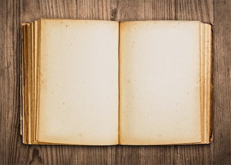 Vintage book, open, on old wooden table, with clipping path. Stock Photo - Budget Royalty-Free & Subscription, Code: 400-05092702