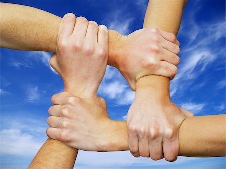 simsearch:600-02671208,k - Linked hands on a white background symbolizing teamwork and friendship Stock Photo - Budget Royalty-Free & Subscription, Code: 400-05107858