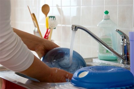 female plumber - Washing dishes in the kitchen Stock Photo - Budget Royalty-Free & Subscription, Code: 400-05116376