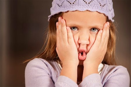 Cute young girl in a knit cap making funny face Stock Photo - Budget Royalty-Free & Subscription, Code: 400-05117119