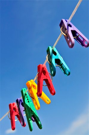 simsearch:400-04263617,k - Colorful clothes pegs on line against blue sky Photographie de stock - Aubaine LD & Abonnement, Code: 400-05113935