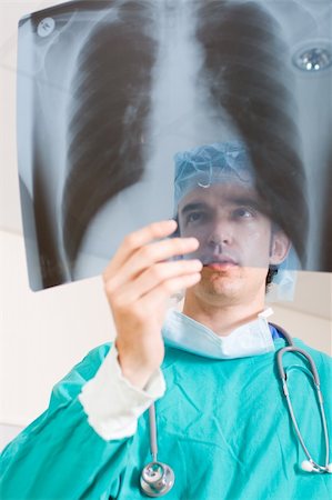 male doctor looking at x-ray film Stock Photo - Budget Royalty-Free & Subscription, Code: 400-05126404