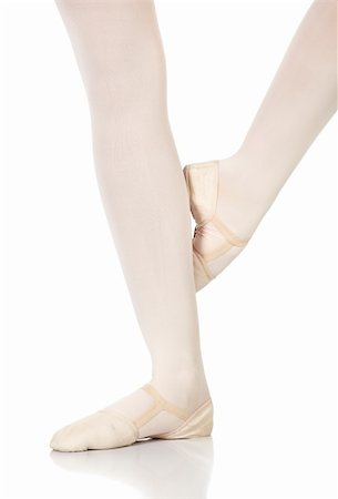 Young caucasian ballerina girl on white background and reflective white floor showing various ballet steps and positions. Petit retire. Not Isolated. Stock Photo - Budget Royalty-Free & Subscription, Code: 400-05122344