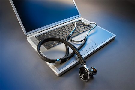 stethoscope placed on laptop keypad in blue colors Stock Photo - Budget Royalty-Free & Subscription, Code: 400-05122942