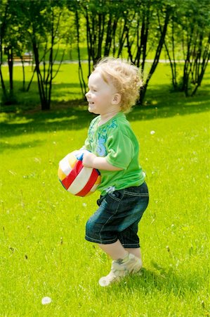 simsearch:400-04638236,k - Happy toddler running with a ball in the park Photographie de stock - Aubaine LD & Abonnement, Code: 400-05136687