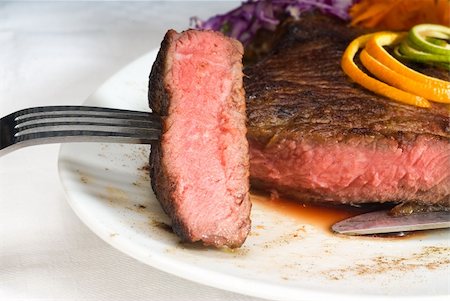 simsearch:400-06079651,k - fresh juicy beef ribeye steak sliced ,with lemon and orange peel on top  and vegetable beside Stock Photo - Budget Royalty-Free & Subscription, Code: 400-05137415
