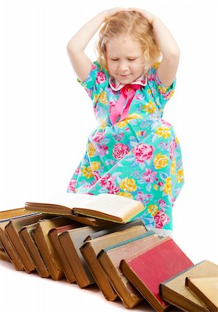 Preschool girl sitting beside large heap of books, her hands on head Stock Photo - Budget Royalty-Free & Subscription, Code: 400-05137575