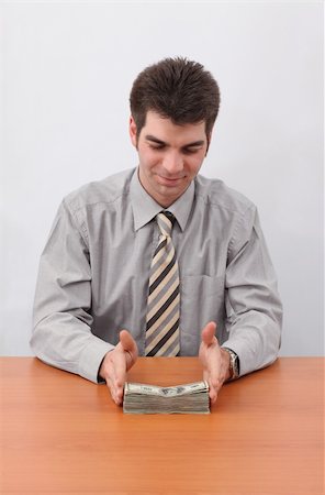 simsearch:400-04529024,k - Young businessman holding a stack of money and planning a financial investment strategy with sitting at the table. Stock Photo - Budget Royalty-Free & Subscription, Code: 400-05130122