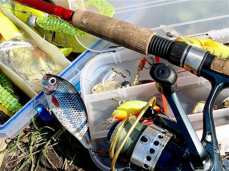 Fishing accessories - lures in the box and rod over them Stock Photo - Budget Royalty-Free & Subscription, Code: 400-05130535