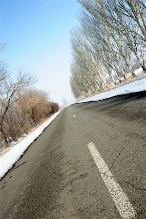 simsearch:400-07215754,k - Road with a marking. A winter line with a snow on a roadside and trees Stock Photo - Budget Royalty-Free & Subscription, Code: 400-05130903