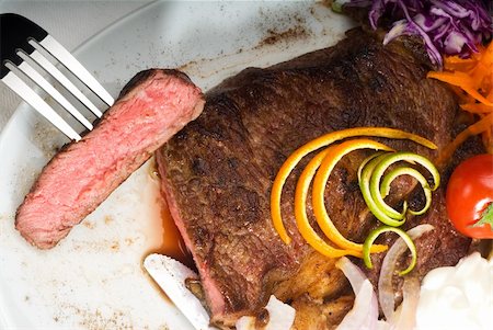 simsearch:400-06079651,k - fresh juicy beef ribeye steak sliced ,with lemon and orange peel on top  and vegetable beside Stock Photo - Budget Royalty-Free & Subscription, Code: 400-05144279