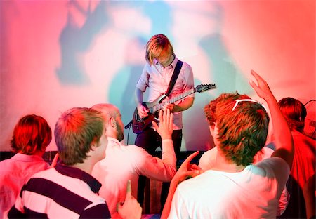picture of the blue playing a instruments - Guitarist, live on stage, in a club with a group of people watching the show Stock Photo - Budget Royalty-Free & Subscription, Code: 400-05140062