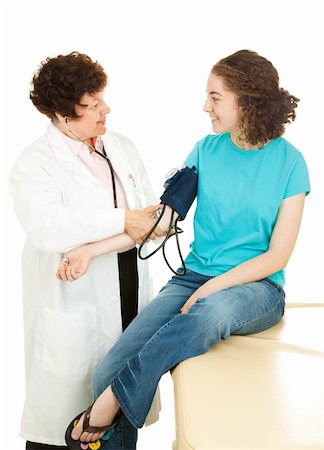 Teenage girl visiting her physician for a checkup.  The doctor is taking her blood pressure. Stock Photo - Budget Royalty-Free & Subscription, Code: 400-05141522