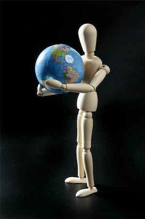 Wooden little mannequin holding a blue world map Stock Photo - Budget Royalty-Free & Subscription, Code: 400-05155038