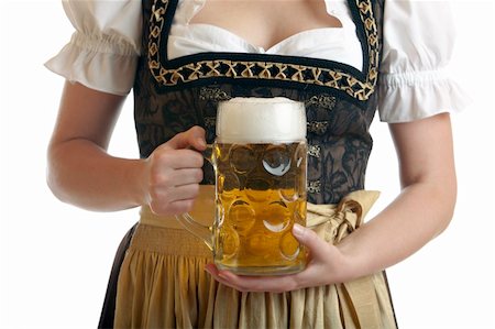 Bavarian Woman in Dirndl holds Beer stein in front of breast at Oktoberfest Stock Photo - Budget Royalty-Free & Subscription, Code: 400-05156344