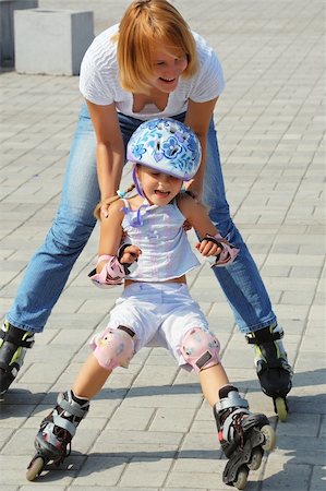 rollerblade girl - daughter and mother having fun on in-lineskates on a sunny summer day Stock Photo - Budget Royalty-Free & Subscription, Code: 400-05167052